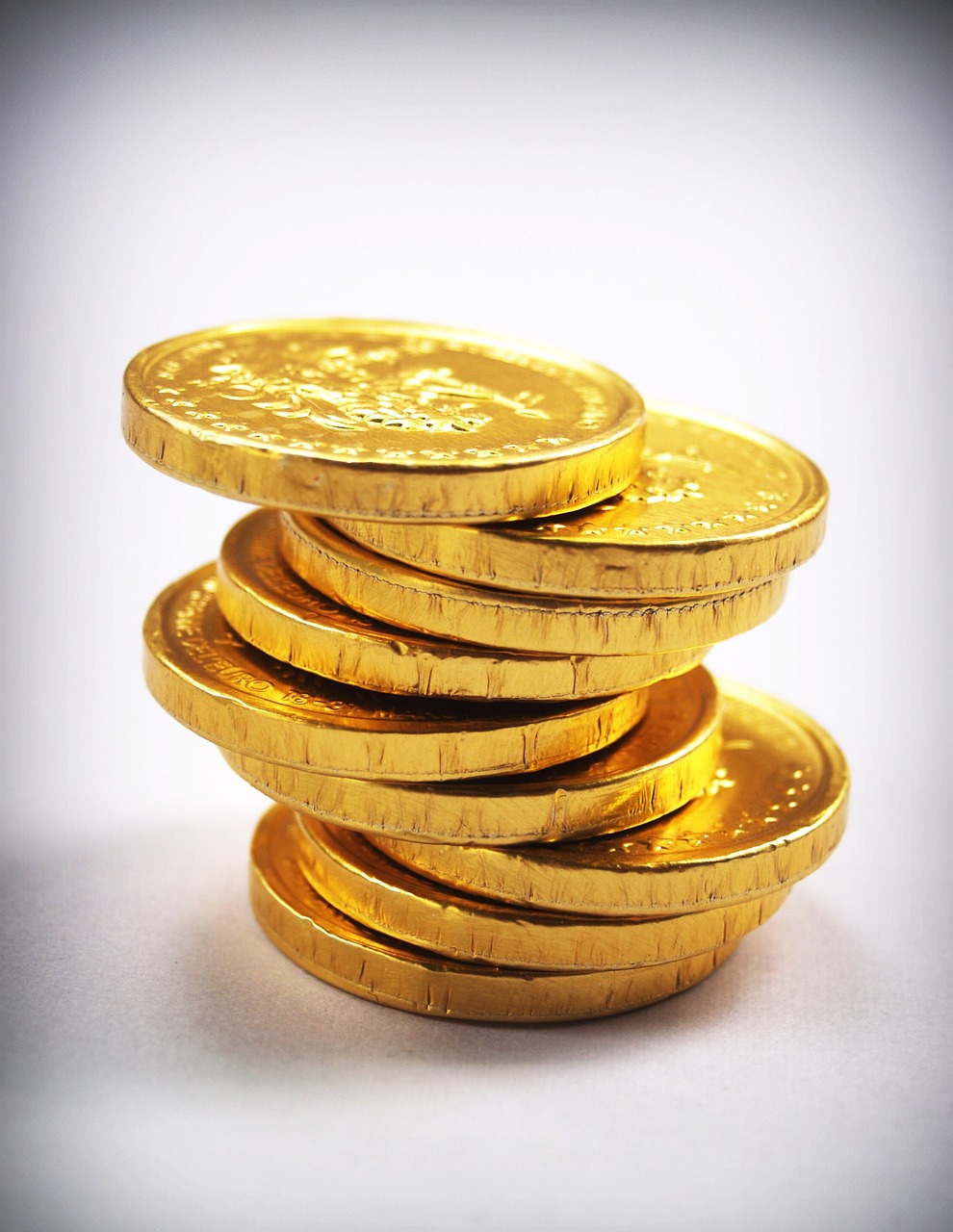 a stack of gold coins sitting on top of each other, a stock photo, by Walenty Wańkowicz, chocolate, highkey, 33mm photo, screencap