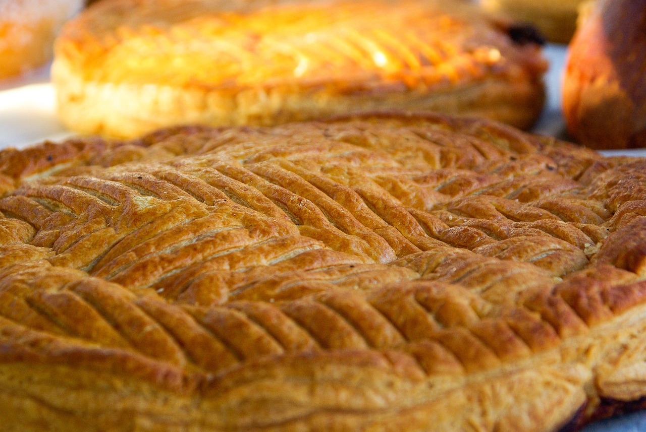 a couple of pies sitting on top of a table, inspired by Normand Baker, pexels, hurufiyya, hdr detail, paris 2010, full of golden layers, market