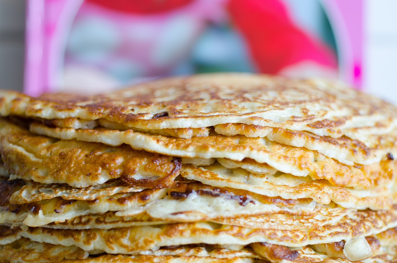 a stack of pancakes sitting on top of a white plate, a portrait, by Aleksander Gierymski, shutterstock, arabesque, detailed zoom photo, 8k 50mm iso 10, folds, 40 years old women