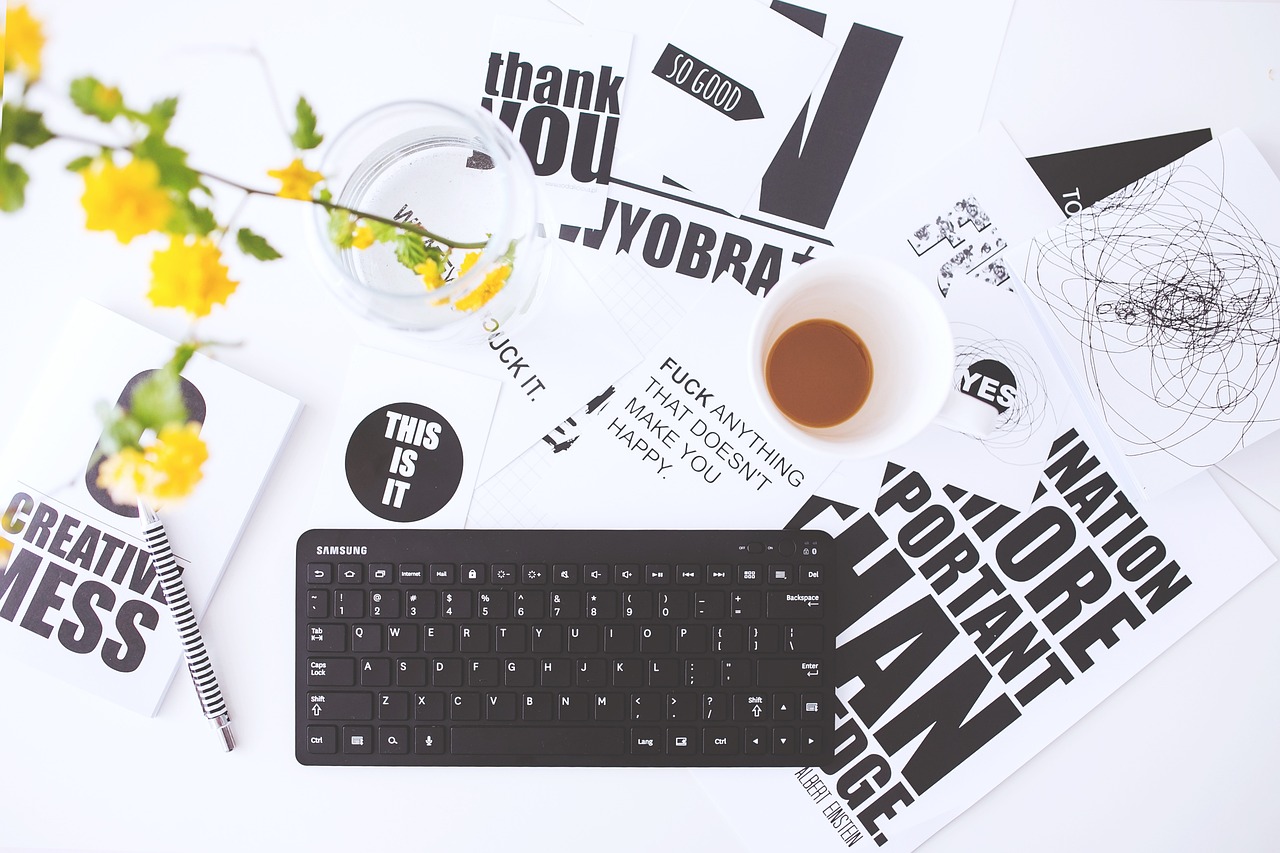 a keyboard sitting on top of a desk next to a cup of coffee, a photo, typographic, various posed, white and black color palette, thank you