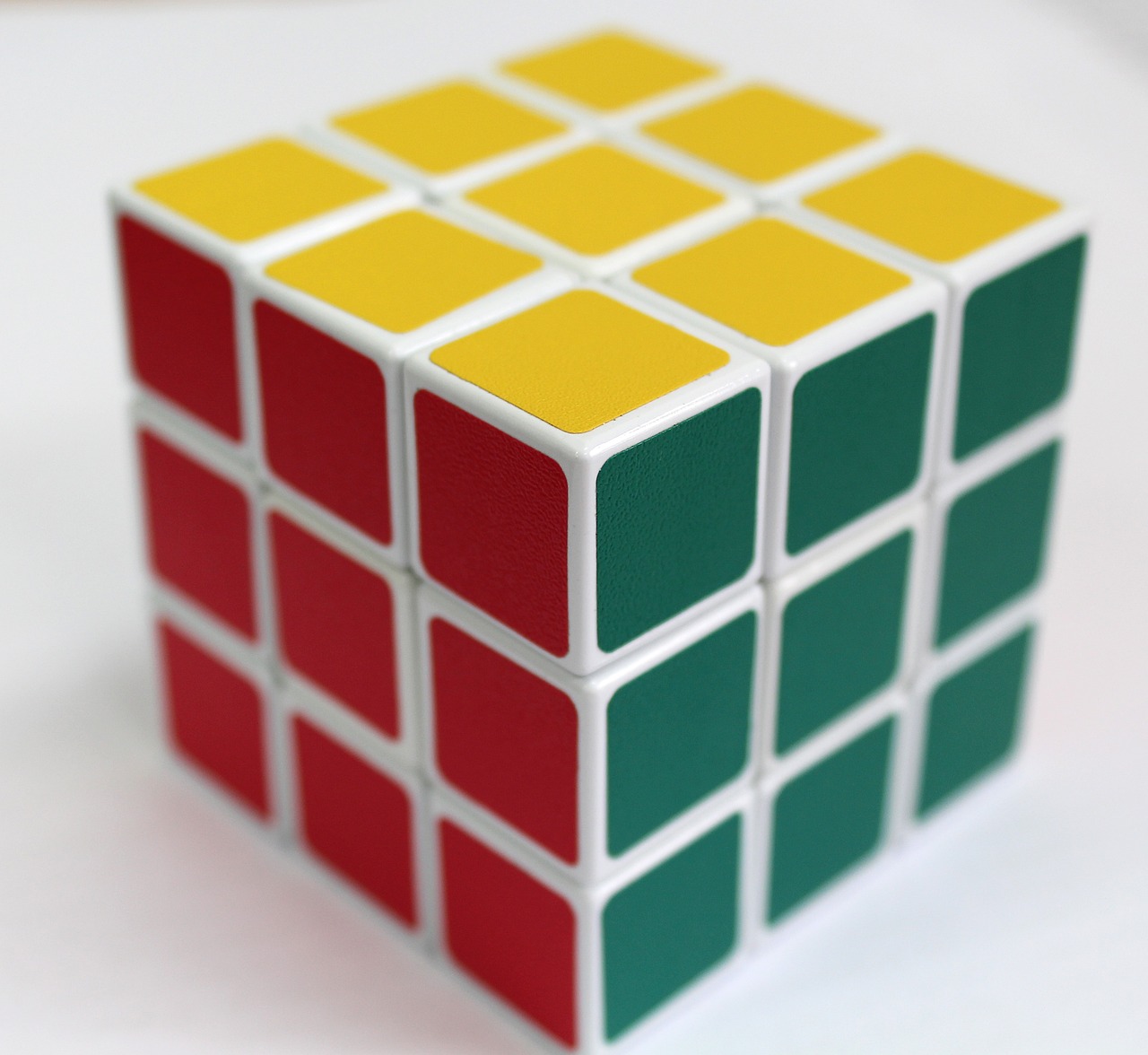 a rubik cube sitting on top of a table, inspired by Ernő Rubik, primary colors are white, highly detailed product photo, subtle pattern, solid colours material