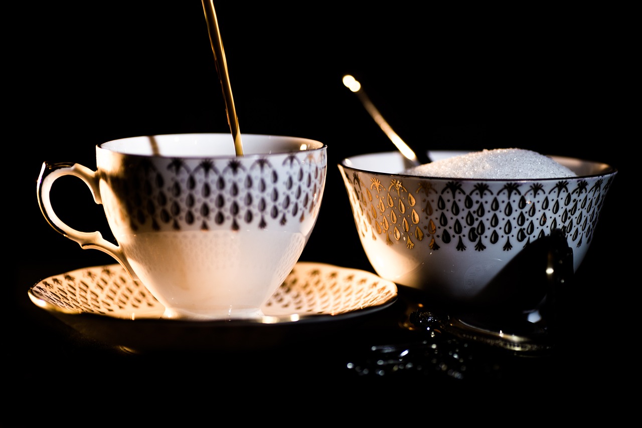 a couple of cups sitting on top of a table, a still life, by Etienne Delessert, pexels, dau-al-set, sugar sprinkled, dramatic lighting !n-9, porcelain organic, pouring