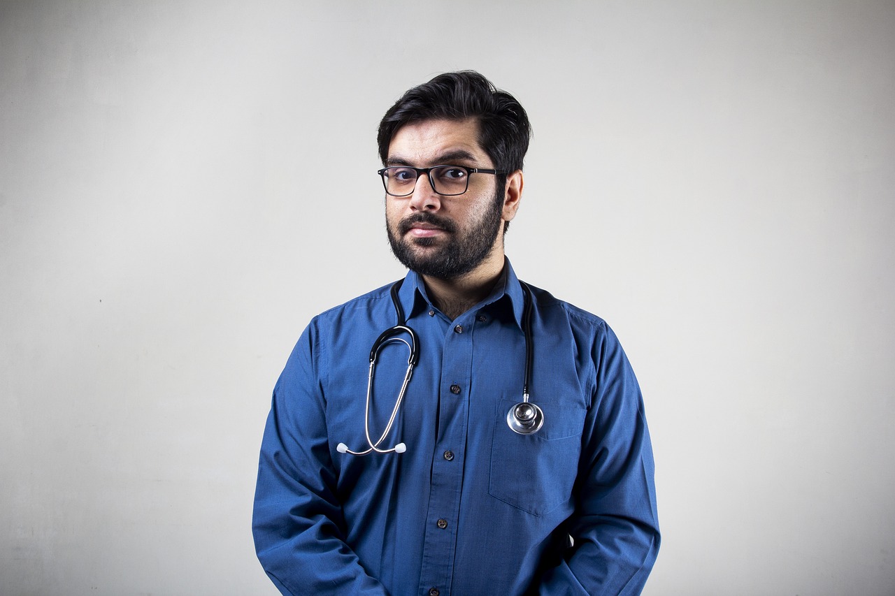 a man in a blue shirt and a stethoscope, by Riza Abbasi, full body photo, lowres, 2 4 years old, muttonchops