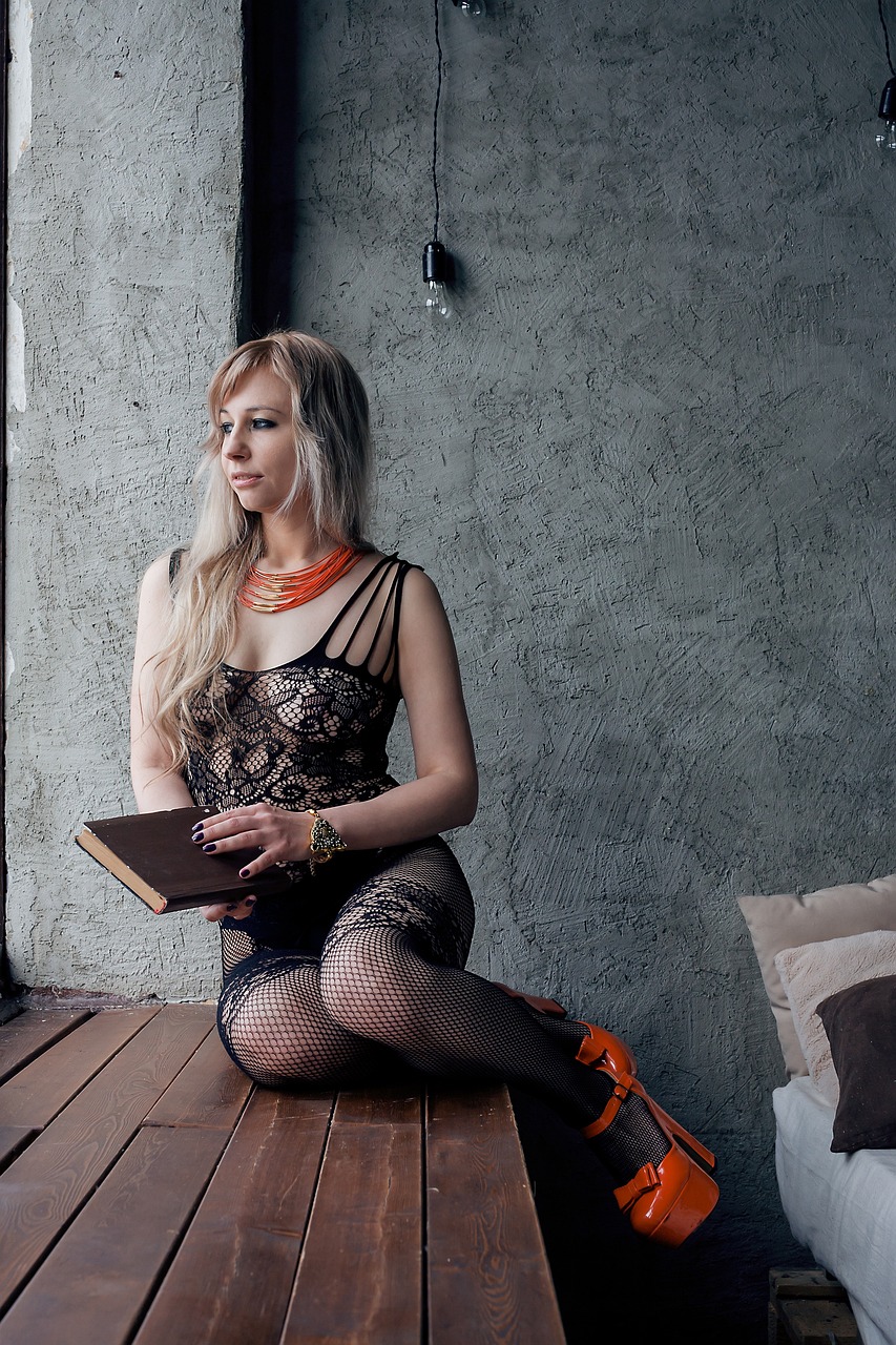 a woman sitting on a wooden bench reading a book, a portrait, inspired by Elsa Bleda, renaissance, fishnet corset with choker, black and orange, blonde beautiful young woman, indoor shot