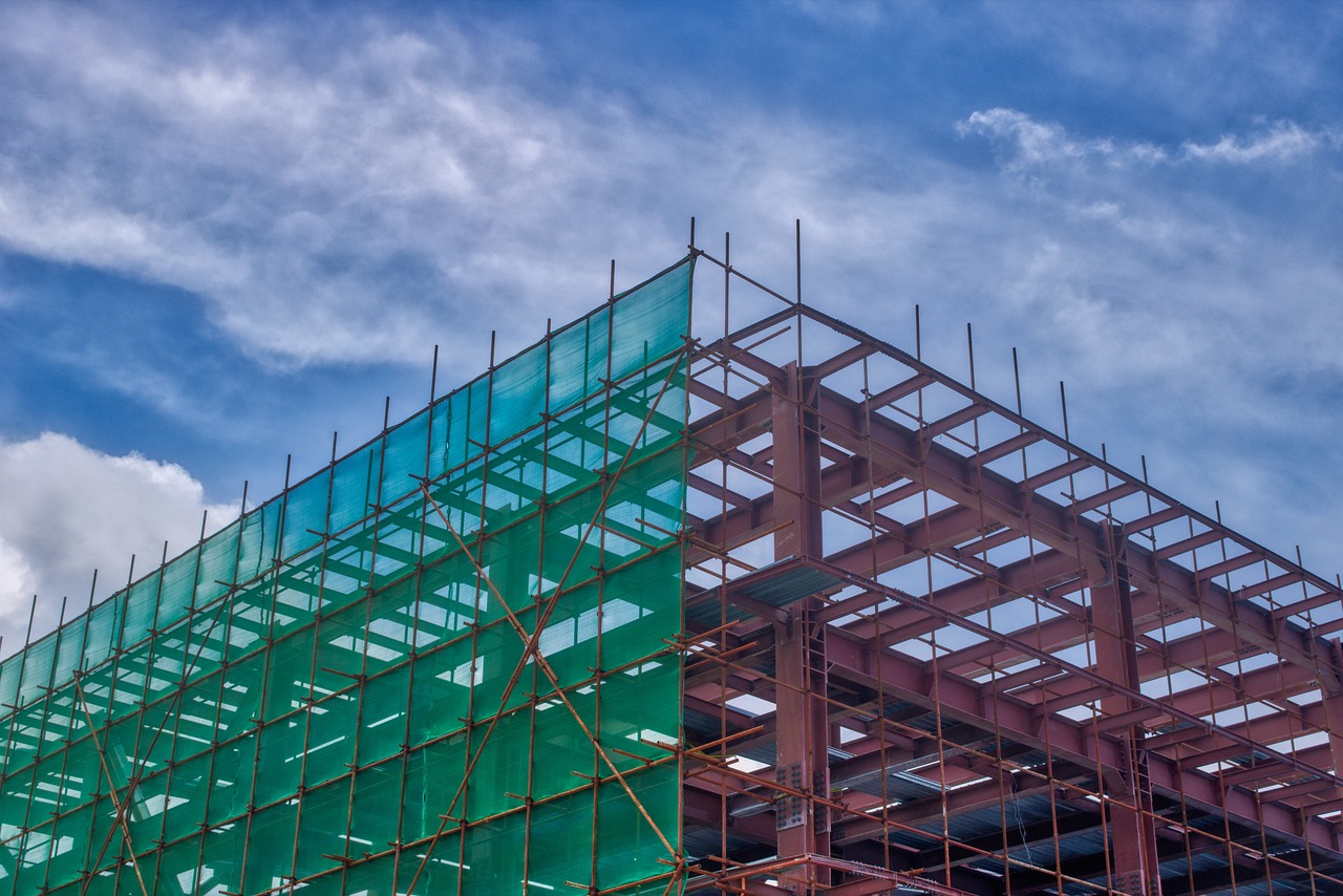 a clock that is on a pole in front of a building, a stock photo, modernism, under construction, cyan and green, mesh structure, red trusses