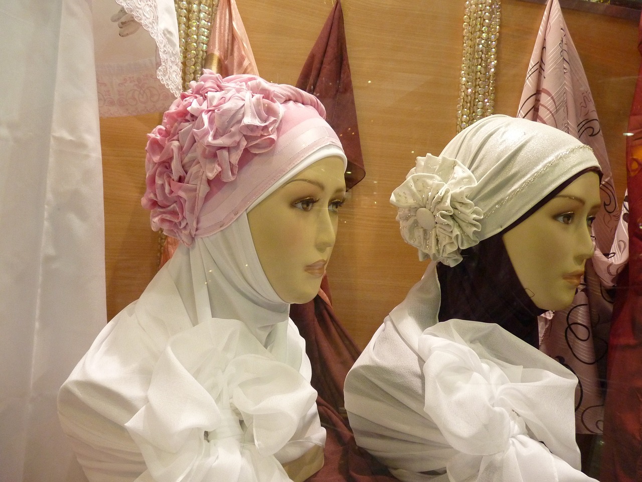 a couple of mannequins sitting next to each other, inspired by Modest Urgell, flickr, hurufiyya, head scarf, white and light-pink outfit, malaysian, face accessories