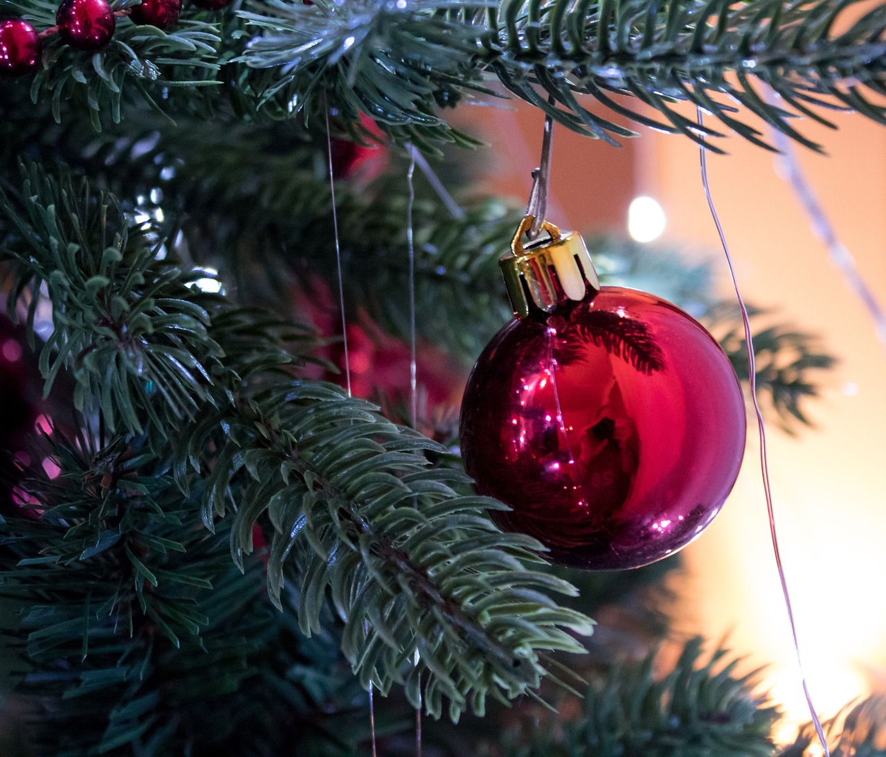 a red ornament hanging from a christmas tree, a portrait, by Maksimilijan Vanka, pexels, bauhaus, - h 1 0 2 4, bottom angle, festive atmosphere, perfect detail