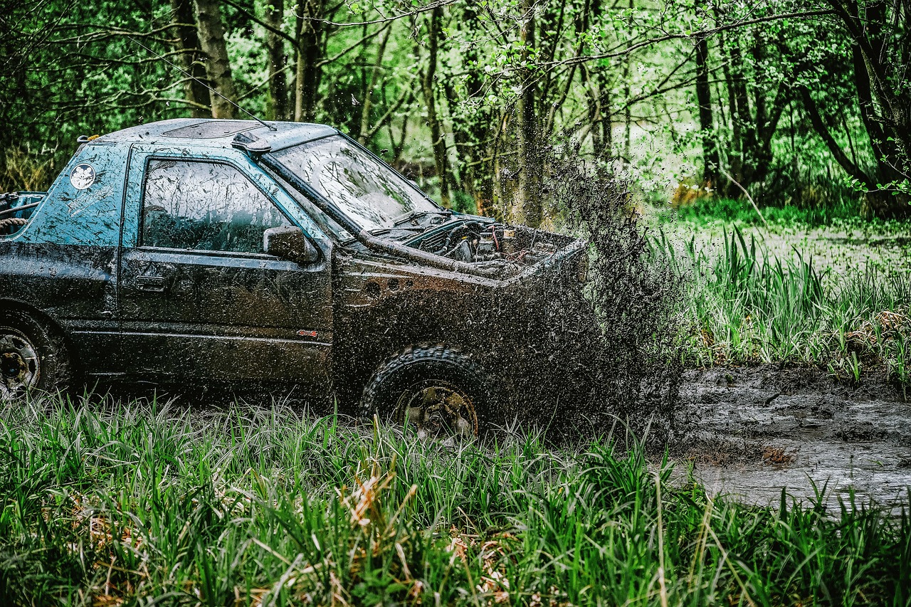 a truck that is sitting in the mud, a picture, by Richard Carline, auto-destructive art, high quality action photography, woodland setting, splashing, gen z