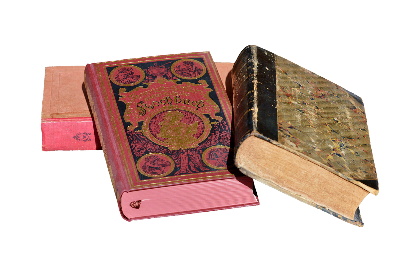 a couple of old books sitting on top of each other, by Jay Hambidge, pixabay, assemblage, pink, three, with ornamental edges, auction catalogue photo