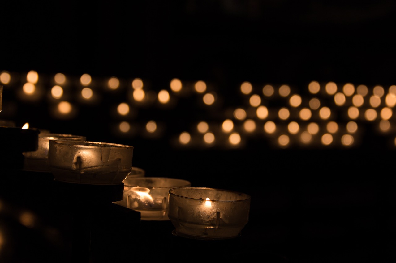 a row of lit candles sitting on top of a table, by Maksimilijan Vanka, pexels, funeral, floating lights, profile picture, praying