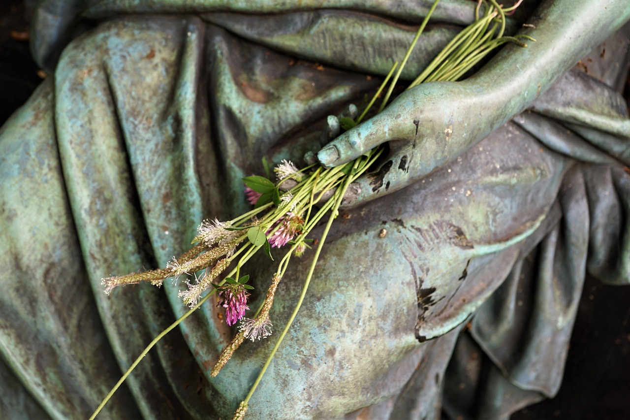 a statue of a woman holding a bunch of flowers, by Anato Finnstark, details, tattered green dress, dried herbs, paris 2010