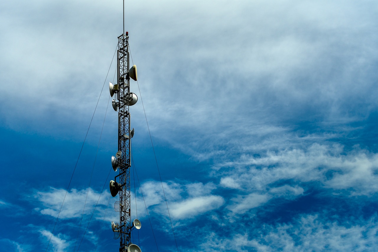 a cell phone tower against a blue sky, pexels, modernism, speakers, against dark background, high above the ground, wisps