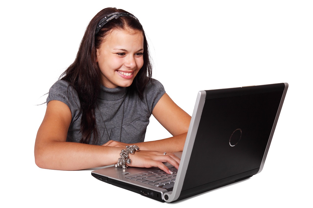 a woman sitting in front of a laptop computer, girl with black hair, dlsr photo, teenage girl, register