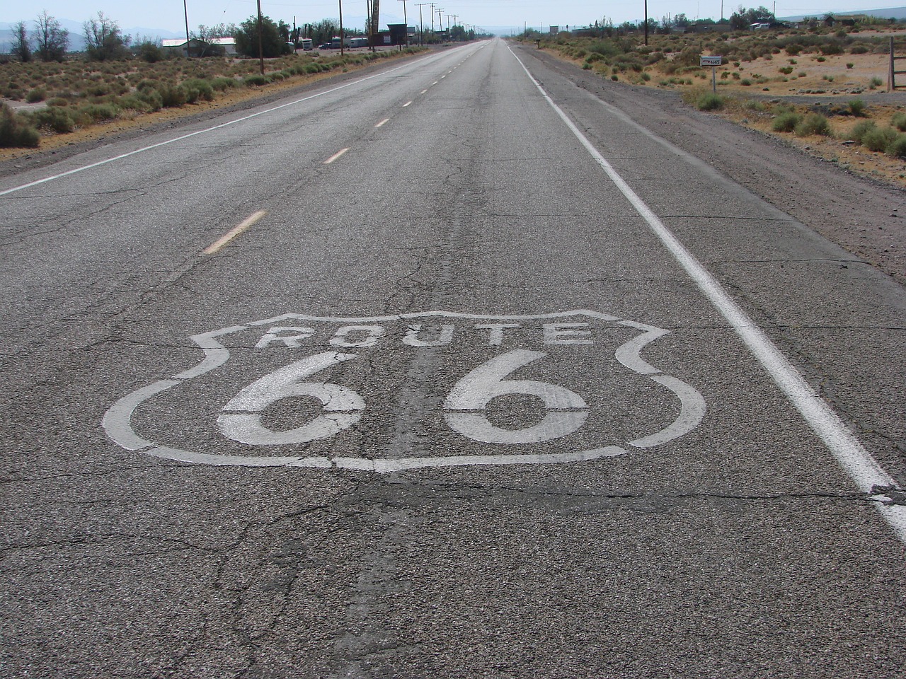 a route 66 sign painted on the side of a road, by Dennis Ashbaugh, flickr, tyre mark, death valley, 6 4 0, -640