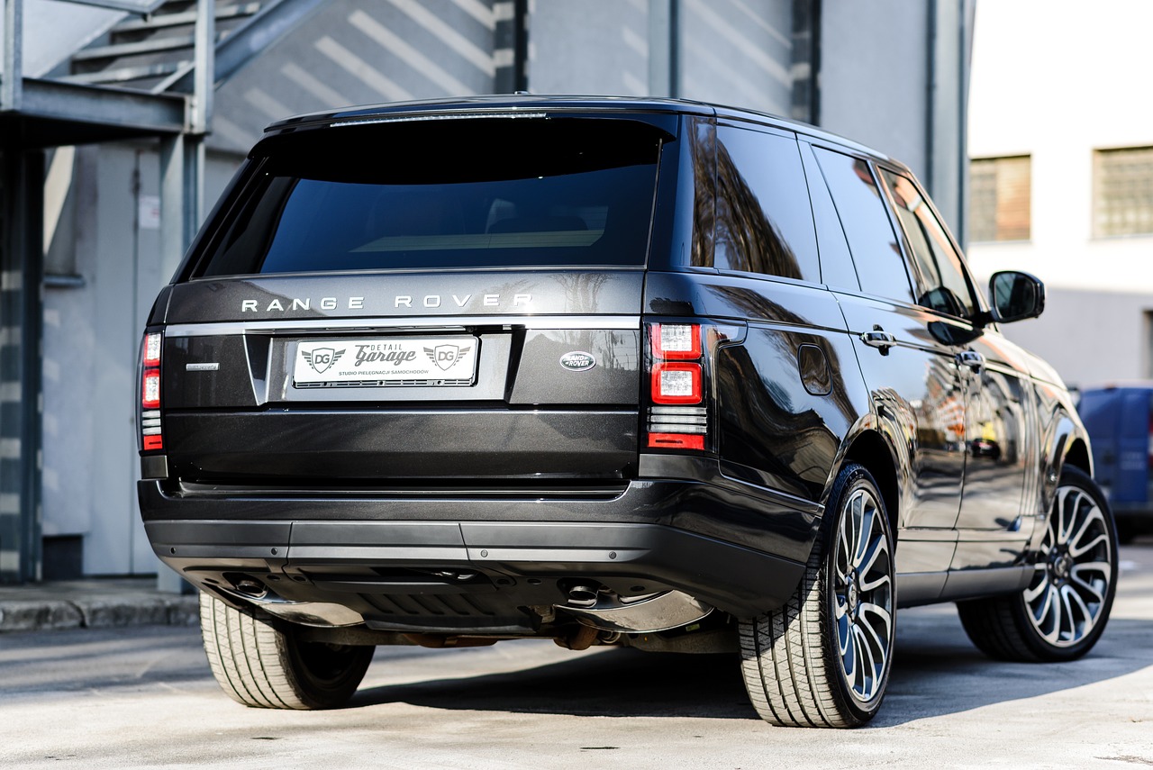 a black range rover parked in front of a building, a picture, shutterstock, pov from rear, extremely polished, engraved, super highly detail