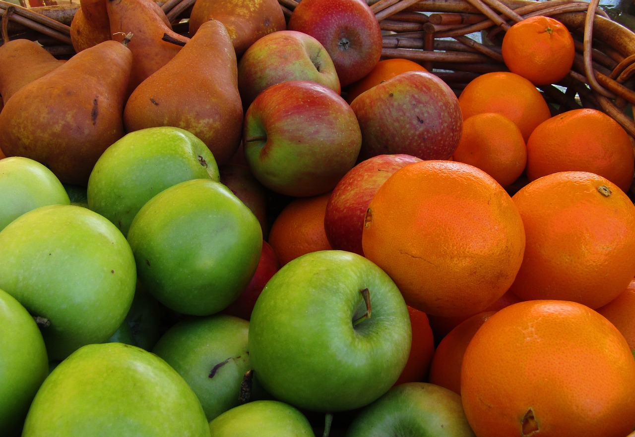 a basket filled with lots of different types of fruit, by Edward Corbett, pexels, figuration libre, bright green dark orange, bottom body close up, taken from the high street, wallpaper - 1 0 2 4