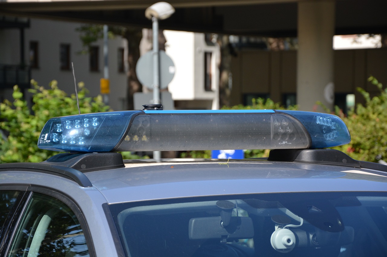 a police car with a blue light on top, by Francesco Raibolini, shutterstock, with a roof rack, closeup photo, directional light, 188216907
