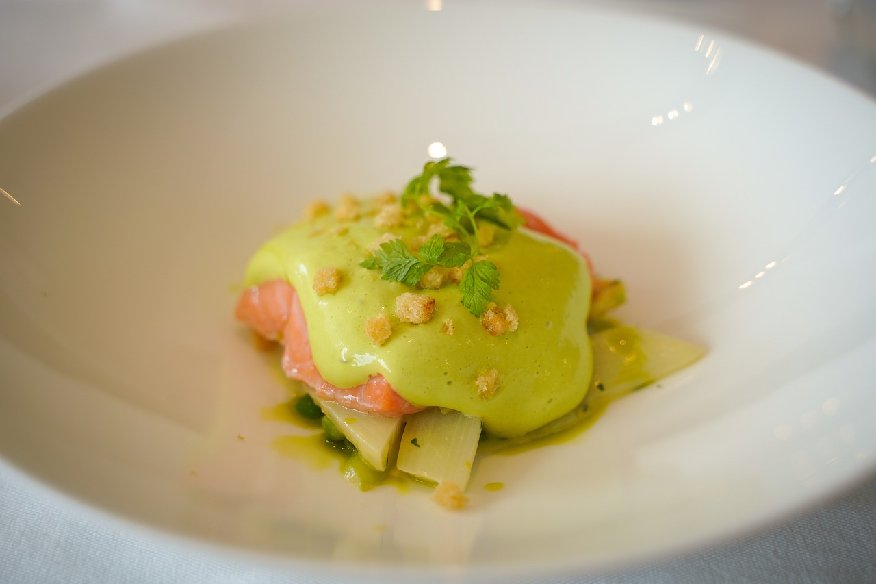 a close up of a plate of food on a table, by Raphaël Collin, full of greenish liquid, salmon, cream, peruvian