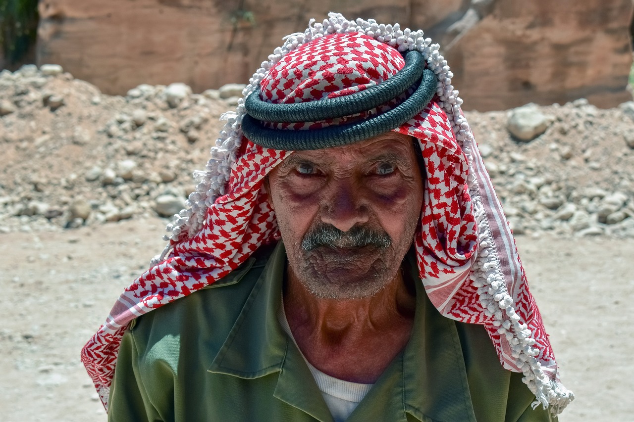 a close up of a person wearing a headscarf, a portrait, dau-al-set, an 80 year old man, sniper! middle age man, stone face, jordan