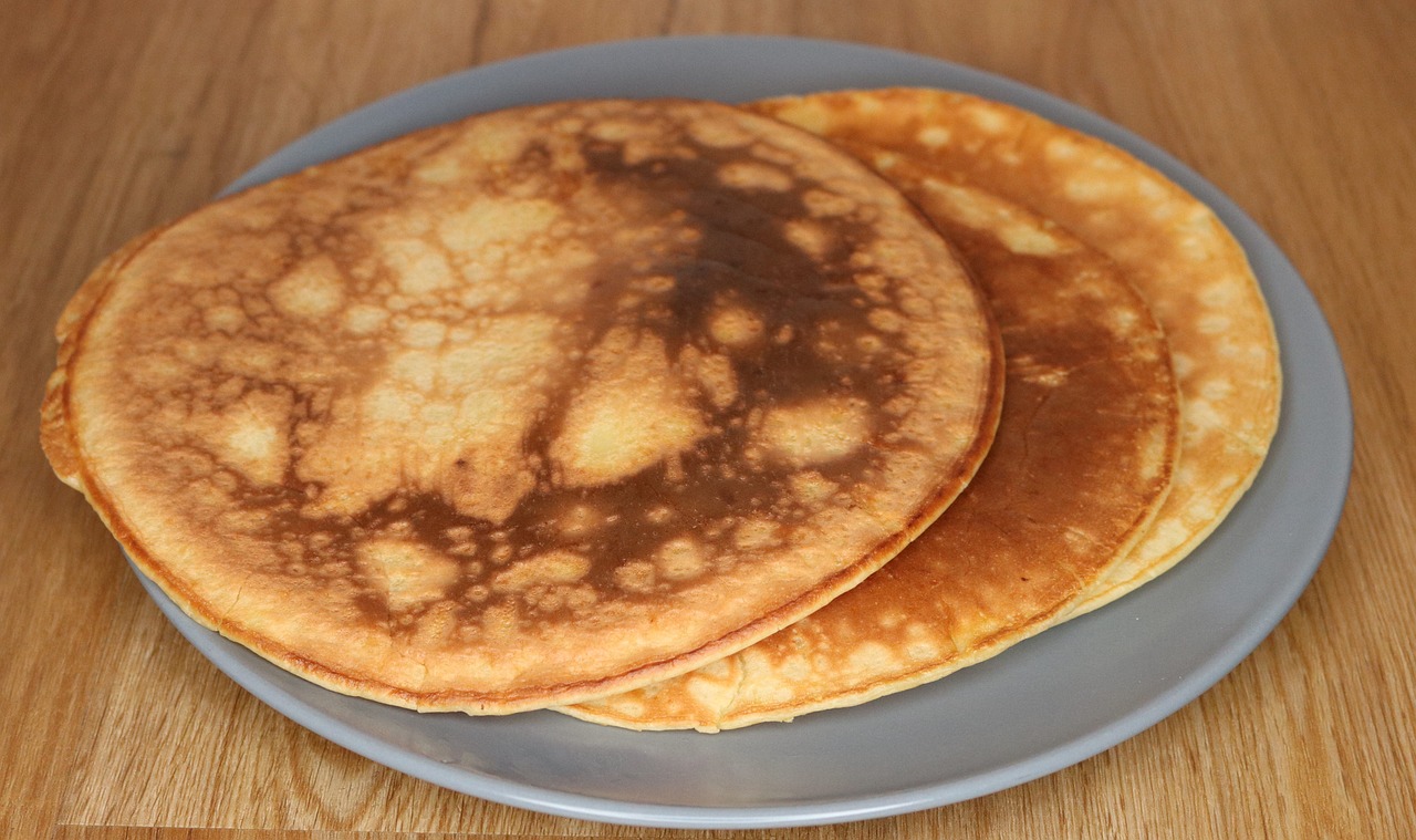 a couple of pancakes sitting on top of a blue plate, hurufiyya, without duplication, 2 1 0 mm, symmetric!, crisp face