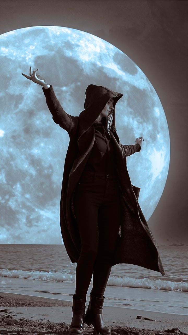 a woman standing on a beach in front of a full moon, inspired by Toshiko Okanoue, pixabay contest winner, digital art, wearing black clothes and cape, ariana grande as a sith, michael jackson moon dance, photograph of a techwear woman