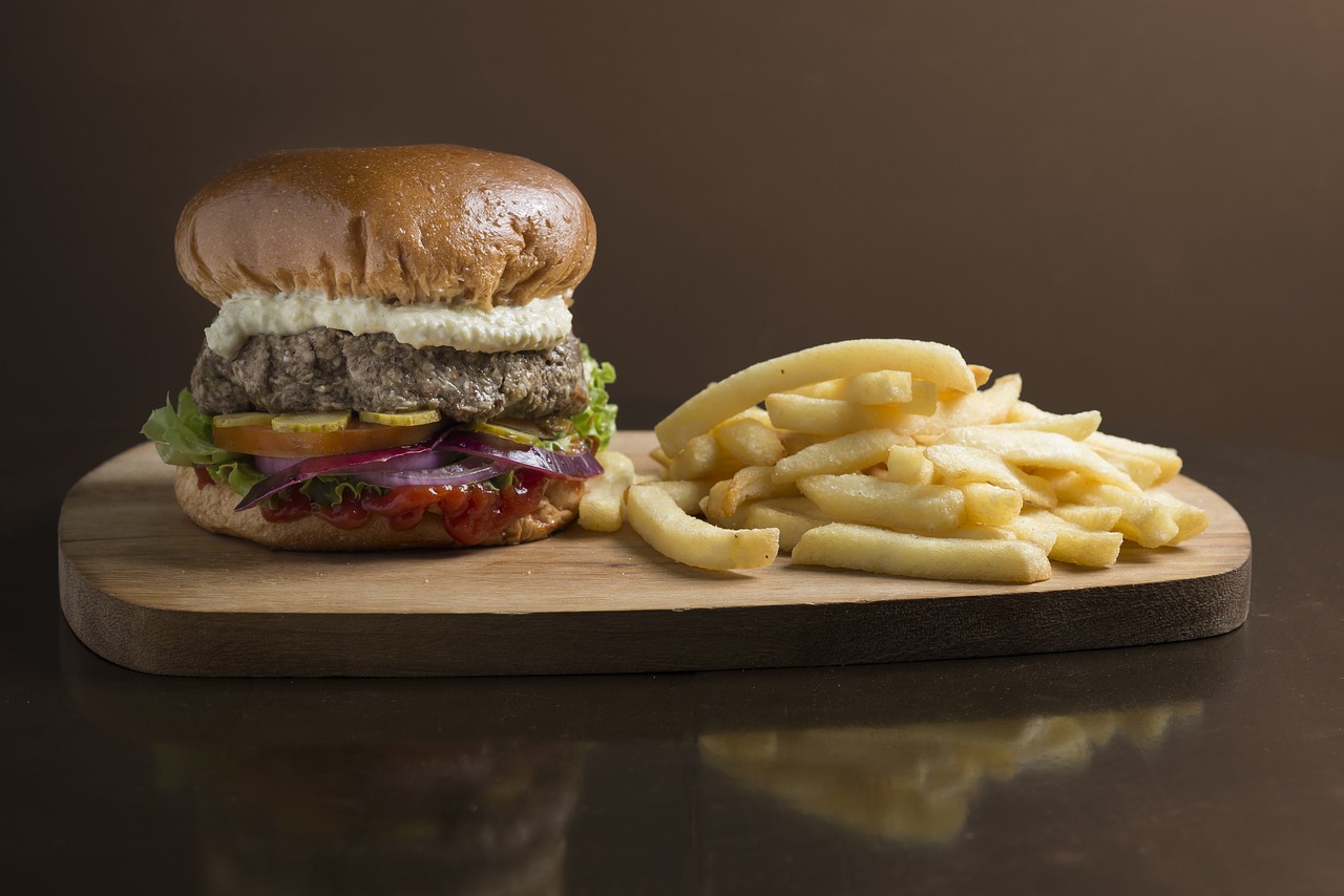 a hamburger and french fries on a cutting board, a picture, by Jay Hambidge, shutterstock, high detail portrait photo, foodphoto, side profile shot, stock photo