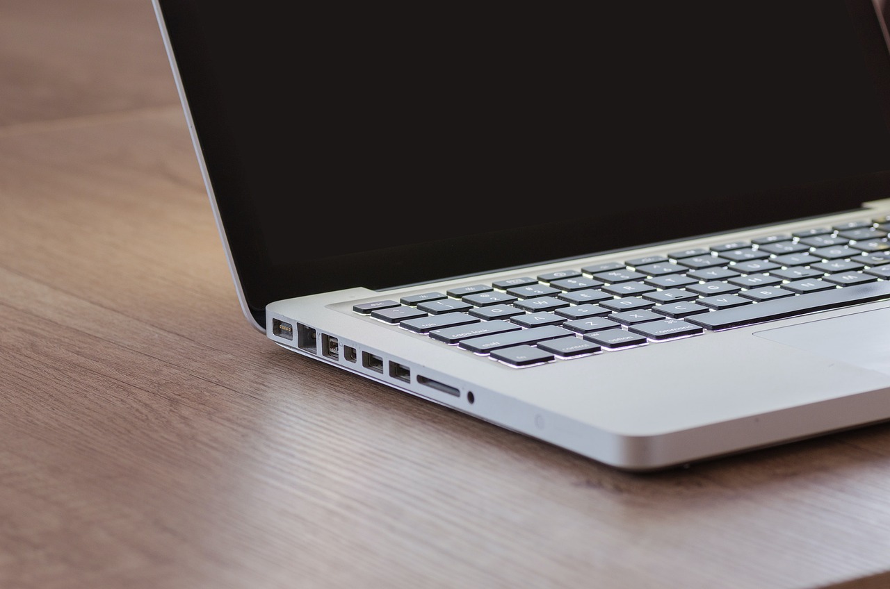 a laptop computer sitting on top of a wooden table, by Jay Hambidge, pixabay, close up shot from the side, rounded corners, modeled, packshot