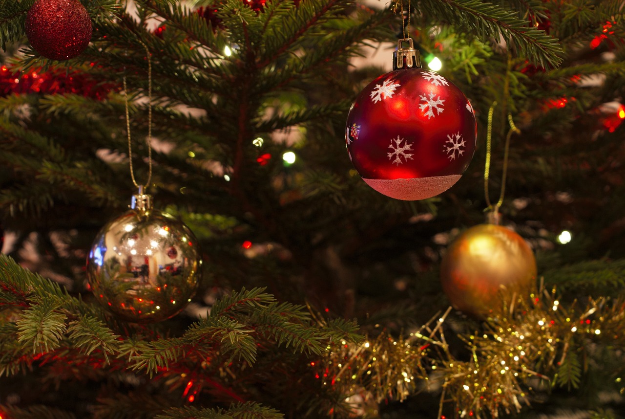 a close up of a christmas tree with ornaments, a picture, by Maksimilijan Vanka, closeup 4k, trio, mid - shot, cosy