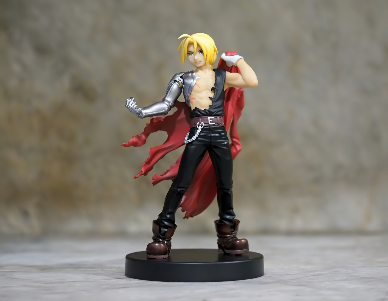 a close up of a figurine of a person with a sword, fullmetal alchemist brotherhood, doing a sassy pose, he-man with a dark manner, product photo