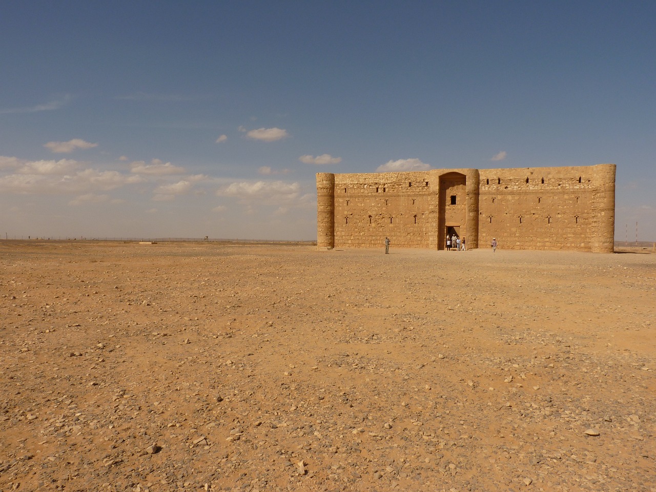 a small building in the middle of a desert, flickr, les nabis, citadel of erbil, a gigantic wall, very very low quality picture, afar