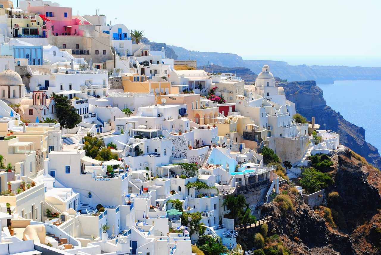 a bunch of buildings that are on the side of a hill, pexels, greek style, crisp colors, breath taking beautiful, cover shot