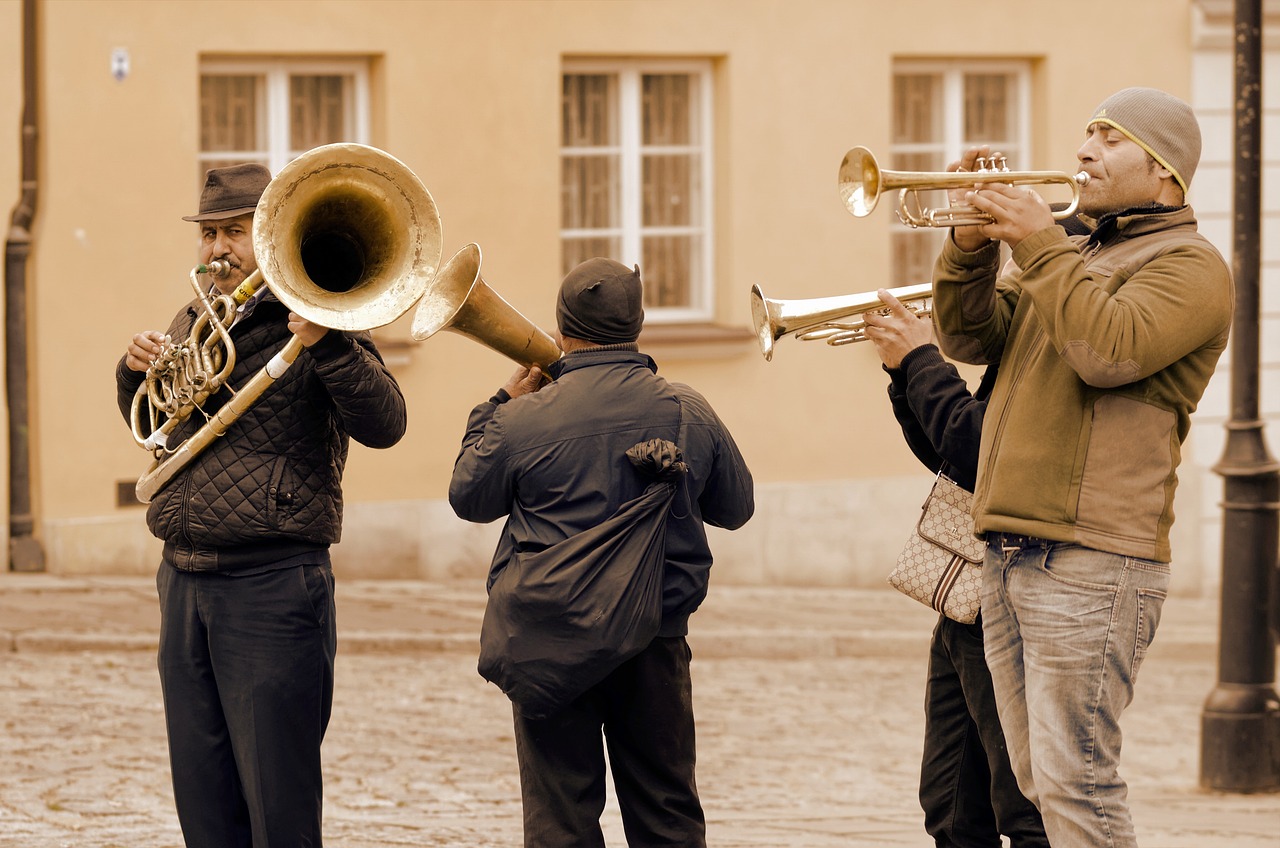 a group of men playing musical instruments on a cobblestone street, a photo, by Walenty Wańkowicz, shutterstock, sousaphone, with large golden pipes, 2 0 1 0 photo, tourist photo