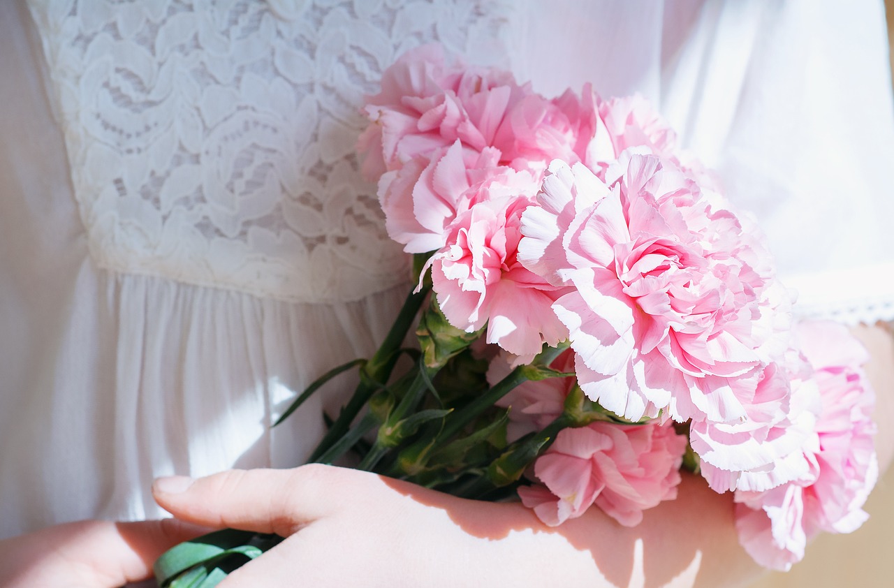 a person holding a bunch of pink flowers, a picture, by Rhea Carmi, romanticism, carnation, sunny light, floral lacework, beautiful hd
