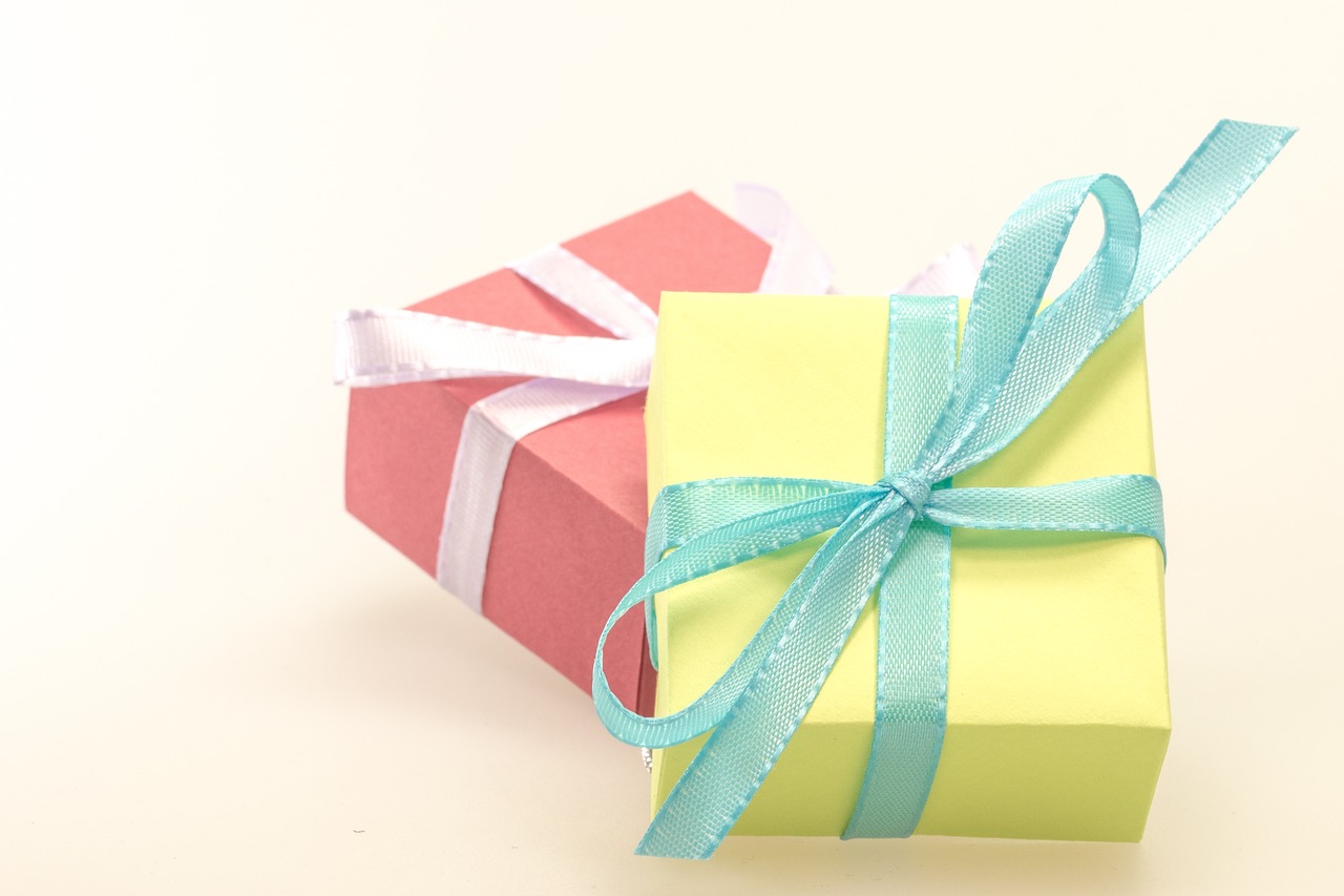 a yellow and pink gift box with a blue ribbon, pixabay, pink white turquoise, two, natural lighting, a green