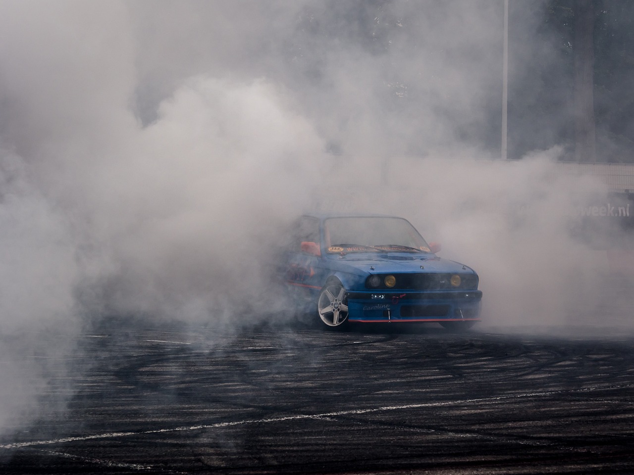 a blue car with a lot of smoke coming out of it, a picture, by Jan Rustem, bmw e 3 0, crazy atmosphere, chalk, podium