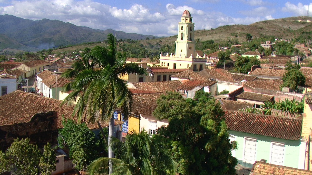 a view of a town with a clock tower, inspired by Ceferí Olivé, cuba, scenic view, tiled roofs, wikimedia