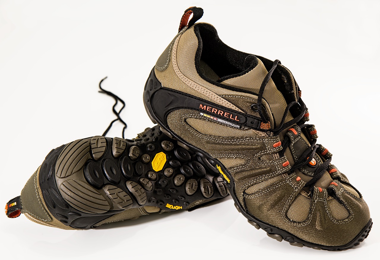 a pair of hiking shoes on a white surface, a picture, by John Murdoch, blog-photo, highly detailed product photo, running shoes, menacing!