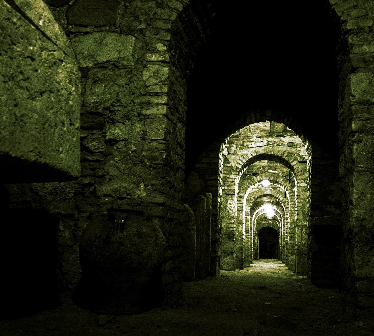 a tunnel in the middle of a stone building, by Thomas Häfner, flickr, romanesque, candlelit catacombs, green, convoluted halls, in a gladiators arena landscape