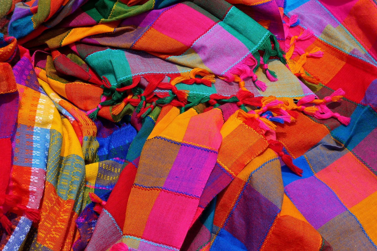 a pile of colorful scarves sitting on top of a table, inspired by Juan O'Gorman, flickr, color field, colorful!!, deep colours. ”, sarong, colorful”