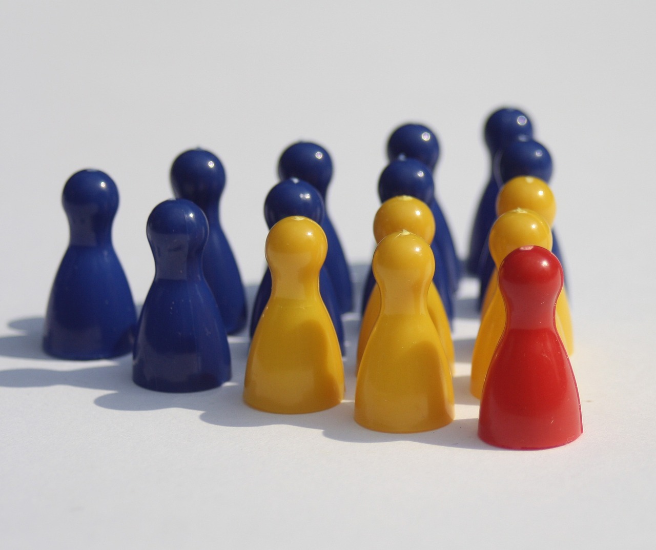 a group of toy people standing next to each other, a picture, plasticien, corn chess board game, red yellow blue, pictured from the shoulders up, 1 figure only