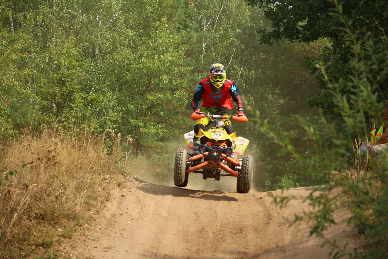 a man riding an atv down a dirt road, a photo, figuration libre, rally driving photo, rutkowskyi, wheelie, low quality photo