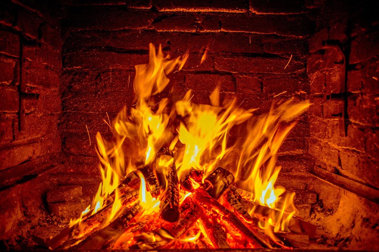 a close up of a fire in a fireplace, a stock photo, shutterstock, fine art, best on adobe stock, brick, wooden, vibrant vivid colors