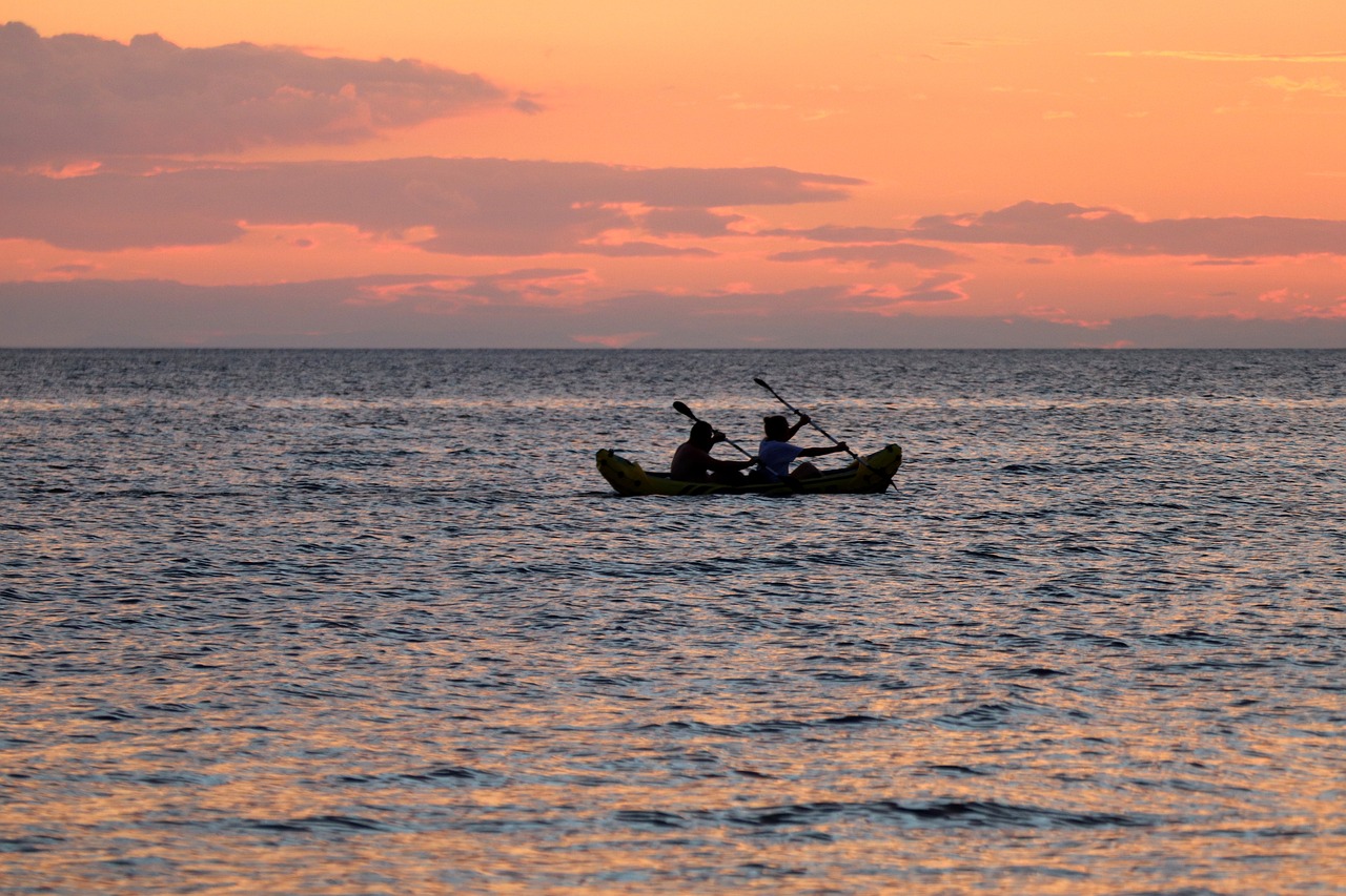 a couple of people that are in a boat in the water, a picture, by Tom Carapic, maui, sunset kanagawa prefecture, gliding, discovered photo