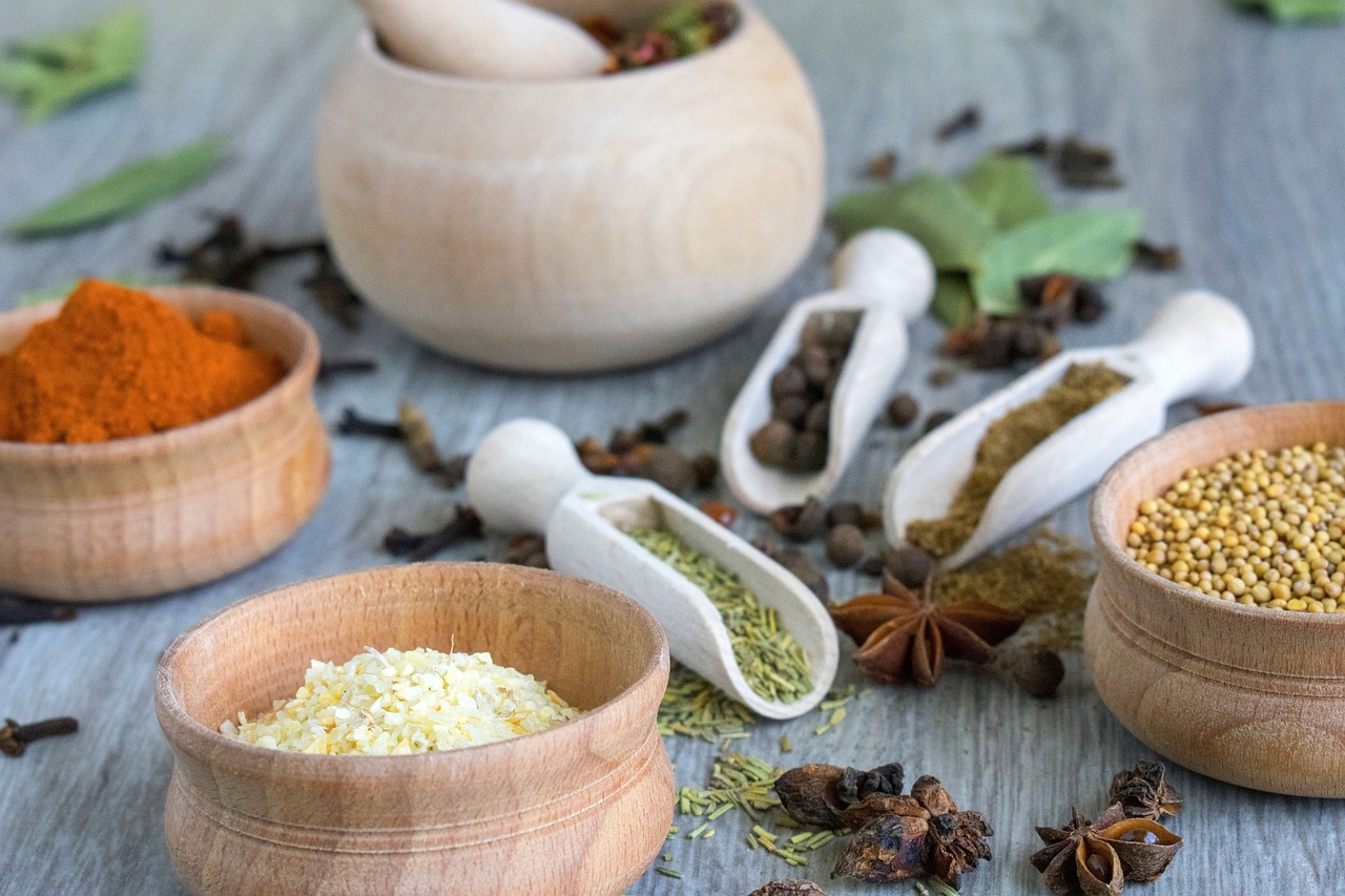 a table topped with wooden bowls filled with different types of spices, full scene, profile picture, feature, foodphoto
