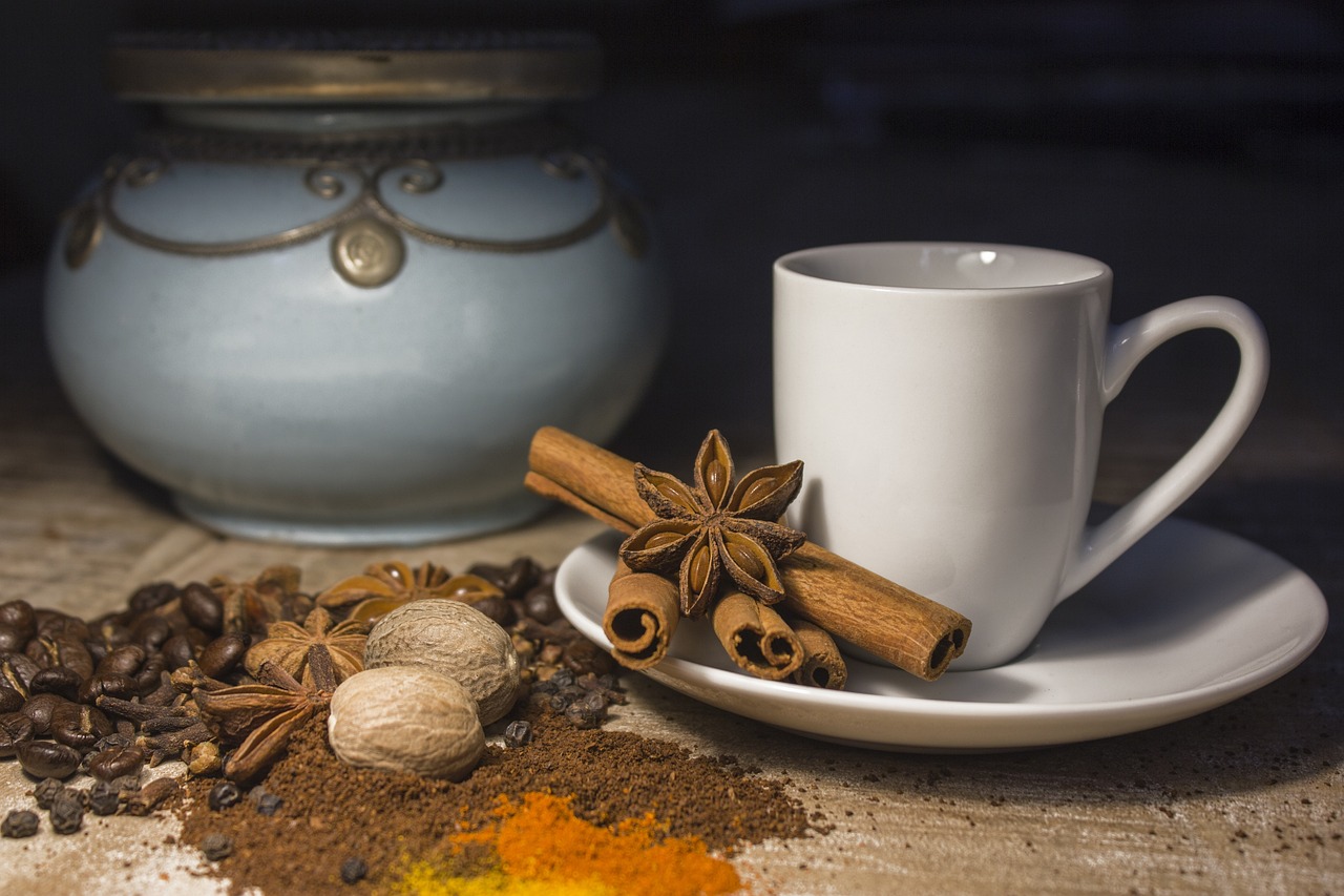 a cup of coffee and some spices on a table, a still life, shutterstock contest winner, renaissance, avatar image, square, india, fan favorite