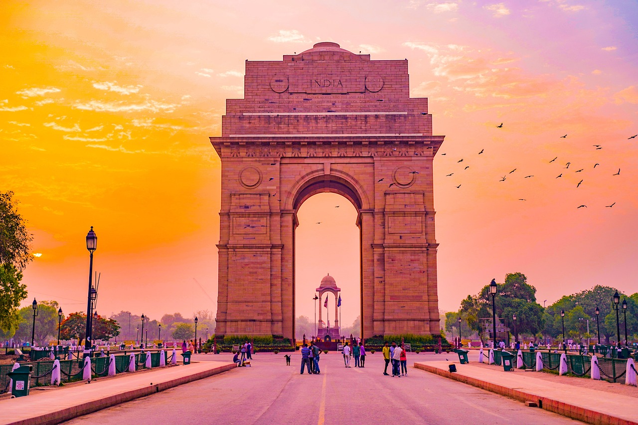 a group of people walking down a street in front of a monument, a picture, pexels contest winner, beautiful futuristic new delhi, tall golden heavenly gates, meadows, massive arch