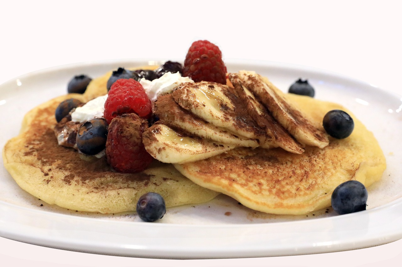 a white plate topped with pancakes and berries, by Dietmar Damerau, video still, banana, 15081959 21121991 01012000 4k, chocolate