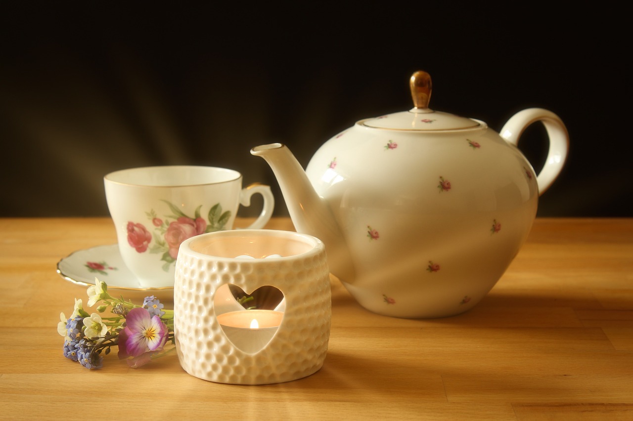 a tea pot sitting on top of a wooden table, a picture, inspired by Wlodzimierz Tetmajer, pixabay, holding a candle holder, engalnd porcelain tea set, trypophobia, high detail product photo