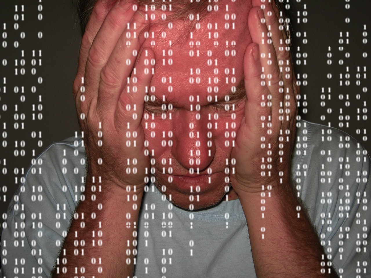a man holding his head in front of a computer screen, a picture, flickr, ascii art, binary, texture, blame, processor