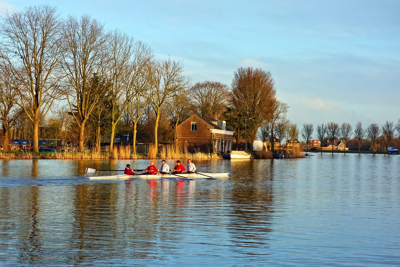 a group of people riding on the back of a boat, a picture, by Jan Tengnagel, shutterstock, small cottage in the foreground, rowing boat, winter setting, sport